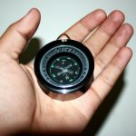 Person holding a magnetic compass